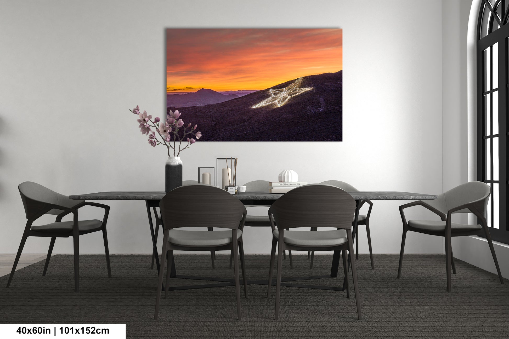 a dining room table with chairs and a painting on the wall