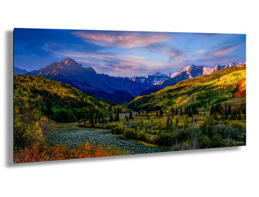 a painting of a valley with mountains in the background