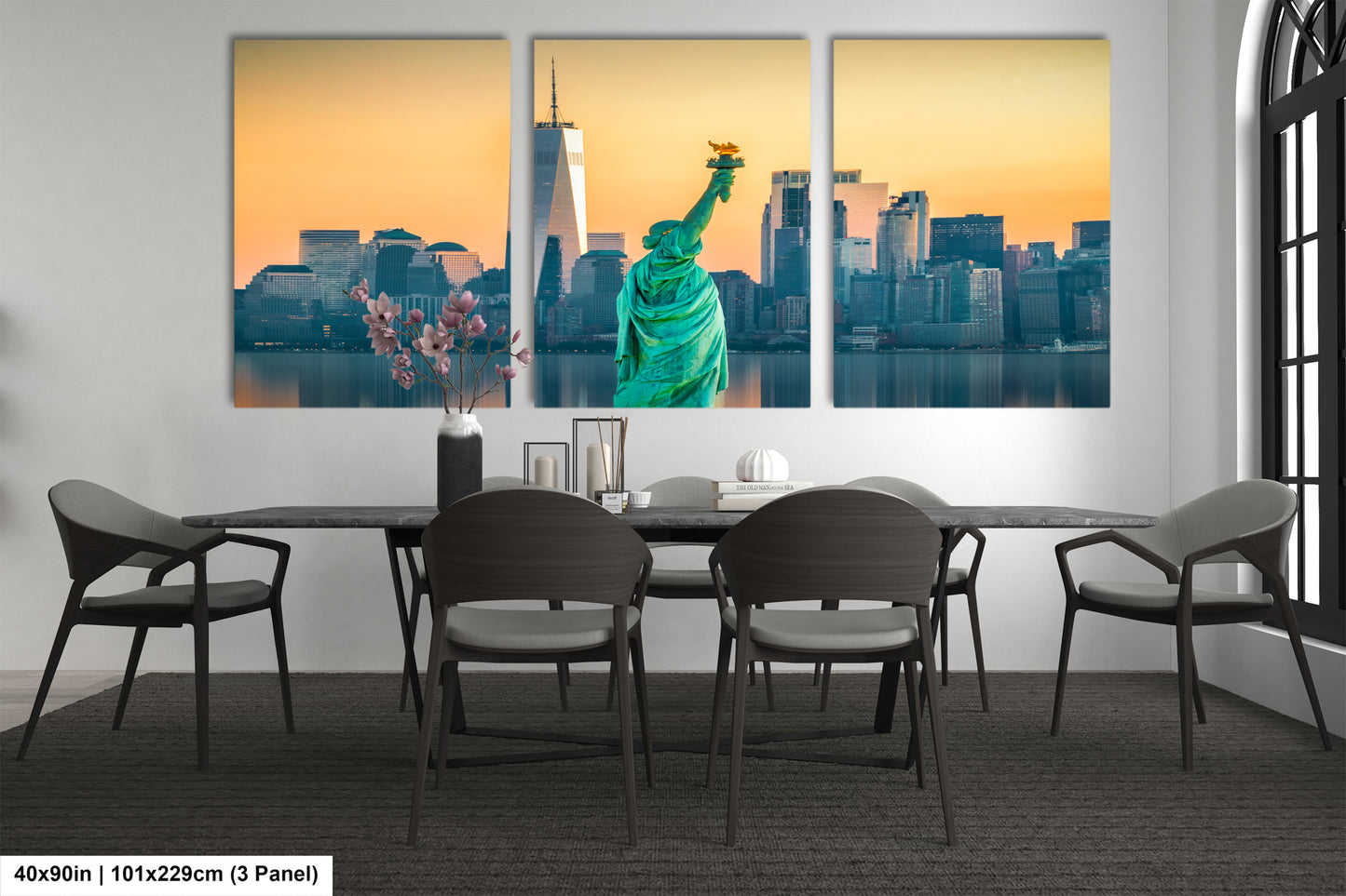 a dining room table with chairs and a picture of the statue of liberty