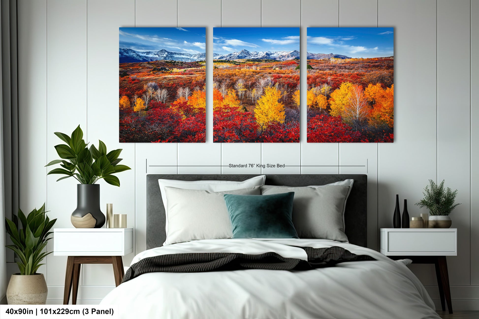 a bedroom with a bed and two paintings on the wall