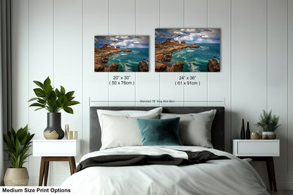 a bed with two pictures on the wall above it