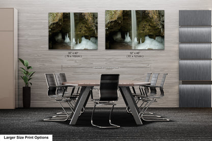 a dining room table with chairs and two pictures on the wall