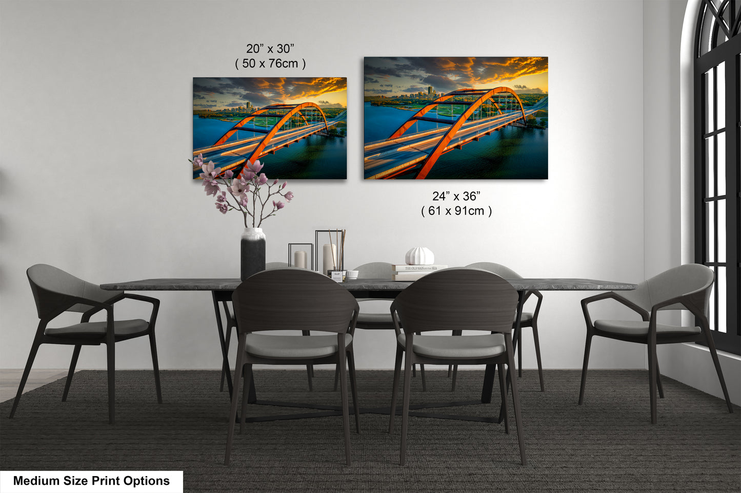 a dining room table with four chairs and a vase of flowers