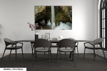 a dining room table with chairs and a waterfall in the background