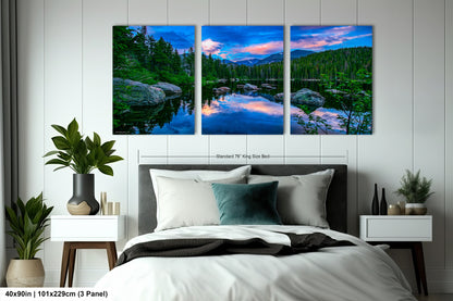 a bedroom with a bed and two paintings on the wall
