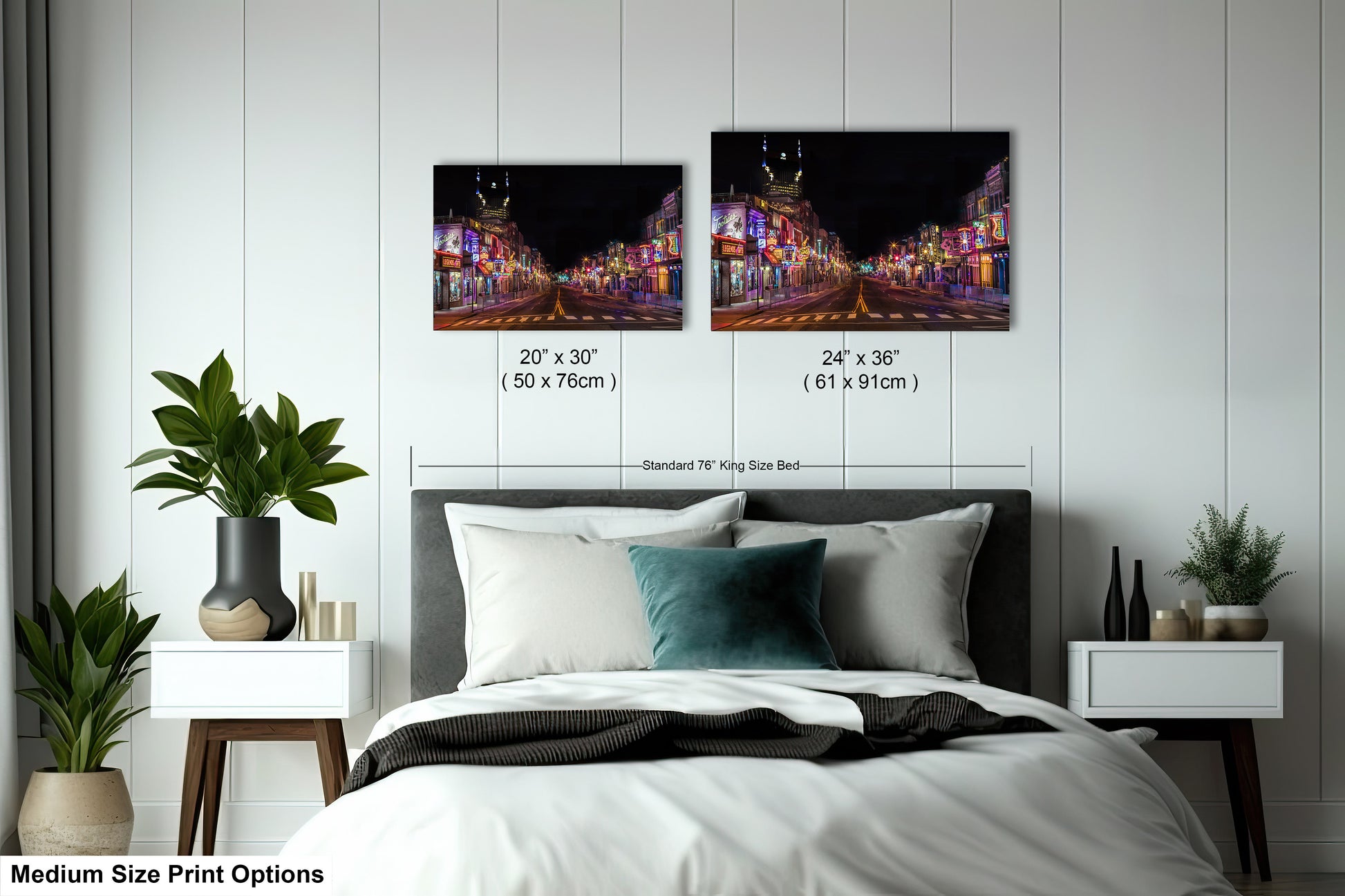 a bed with a white comforter and two pictures on the wall above it