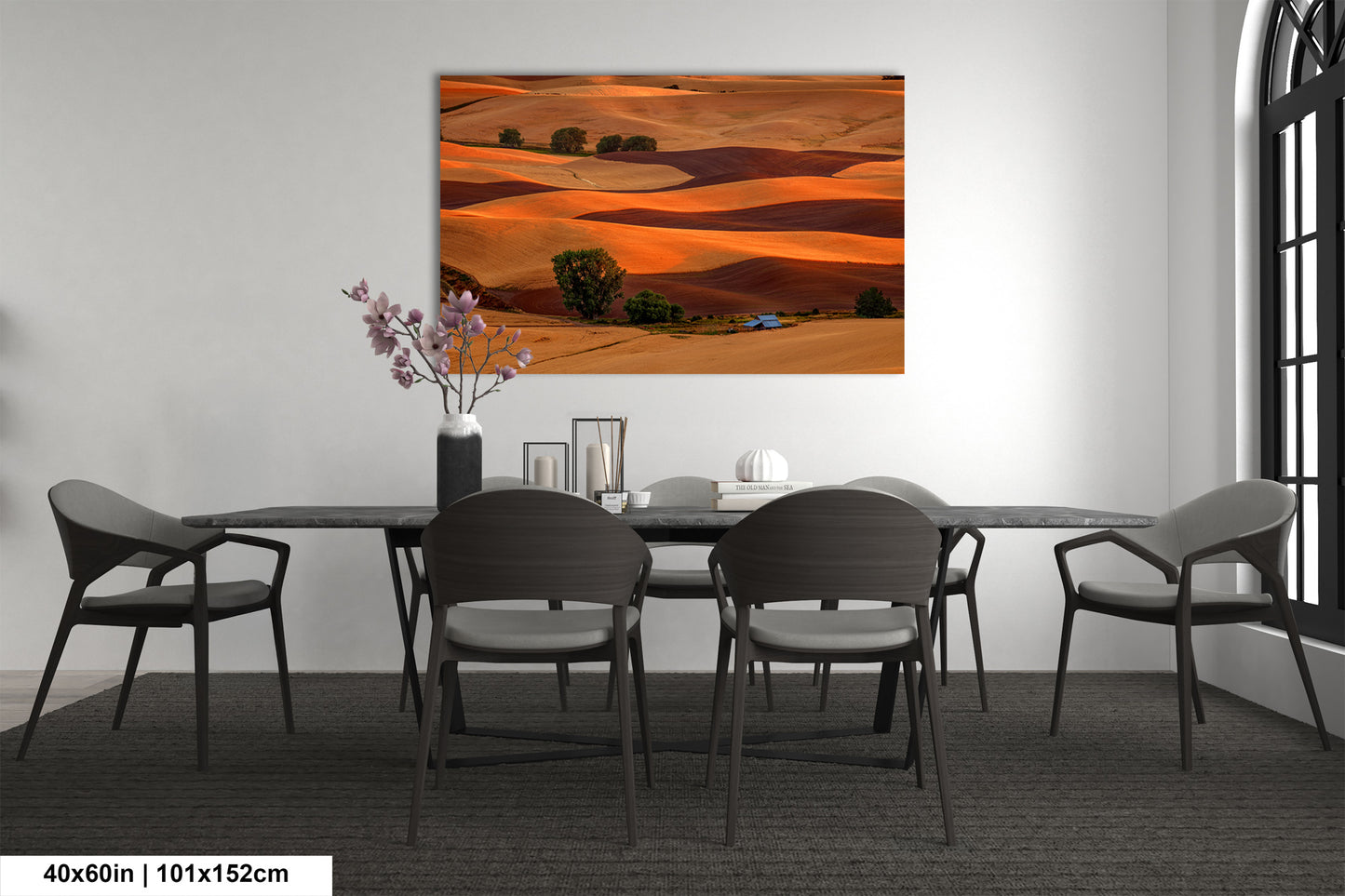 a dining room table with chairs and a painting on the wall