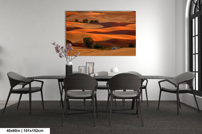 a dining room table with chairs and a painting on the wall