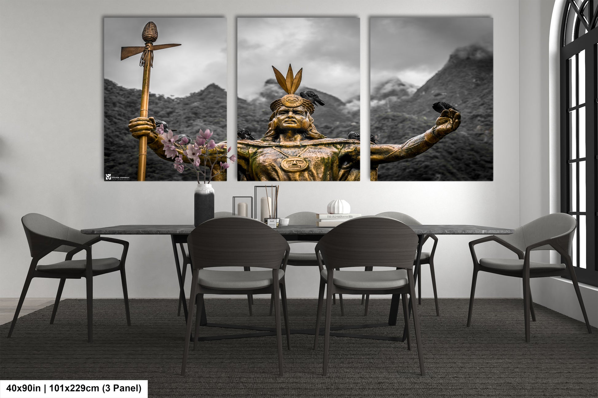 a dining room table with chairs and paintings on the wall