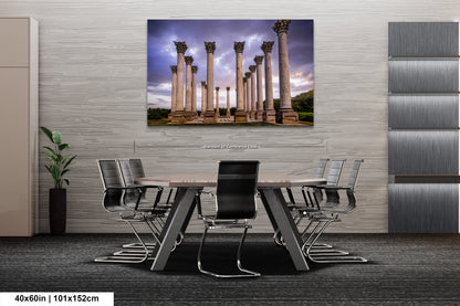 a room with a table and chairs and a painting on the wall