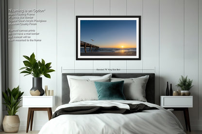 a bedroom with a bed and a picture hanging on the wall