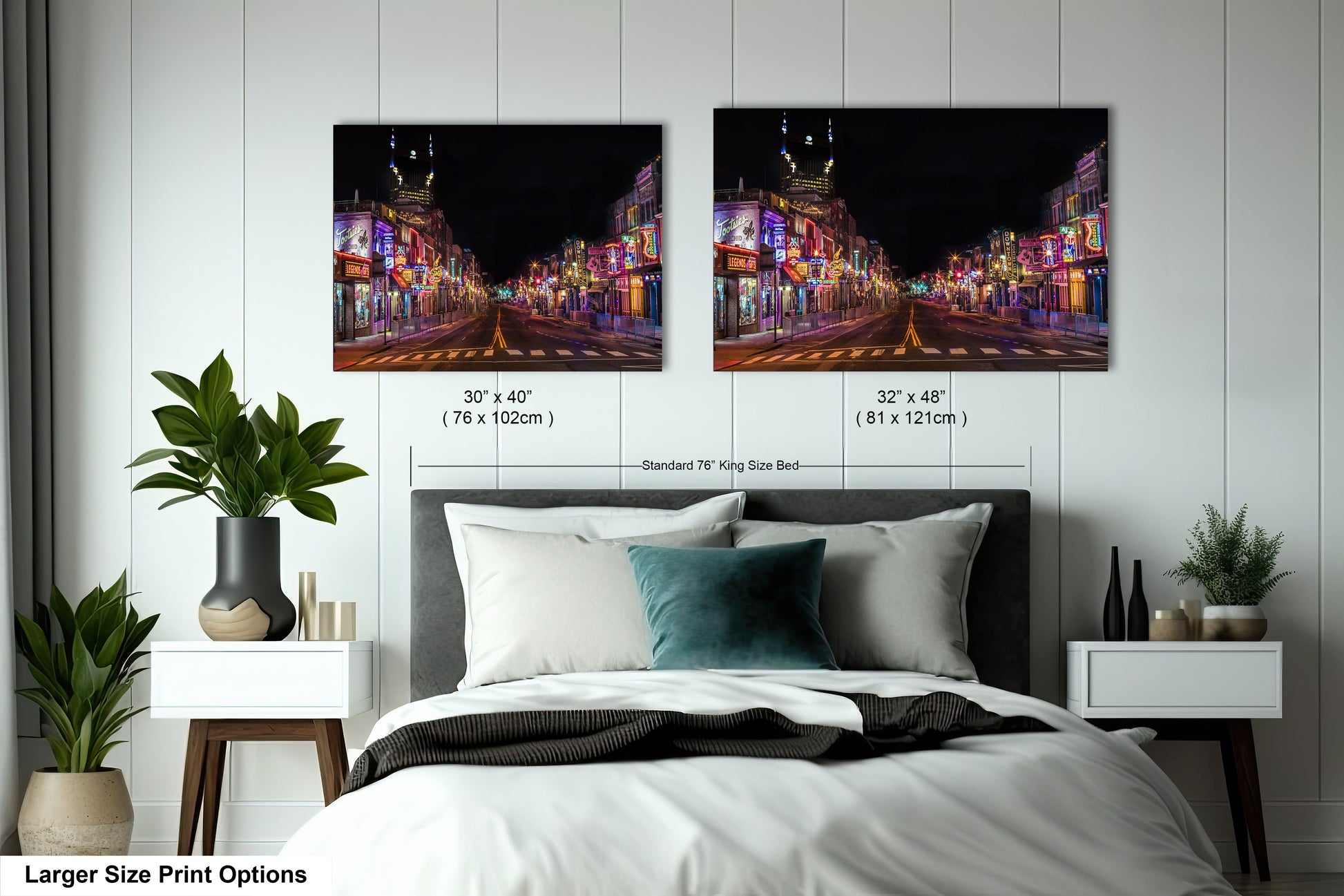 a bed with a white comforter and two pictures on the wall above it