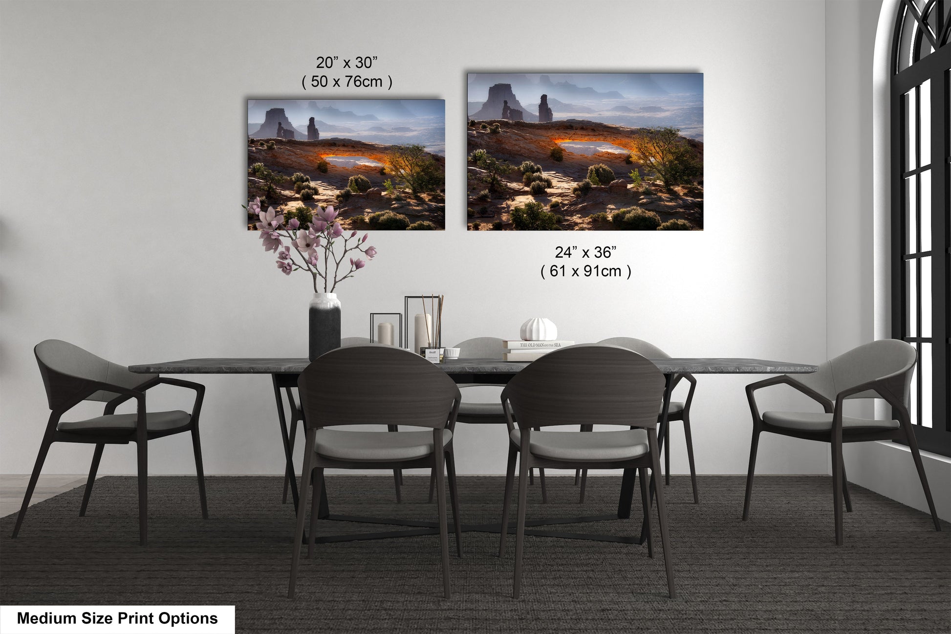 a dining table with four chairs and a vase of flowers