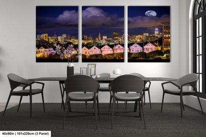 a dining room table with four chairs and a view of a city at night