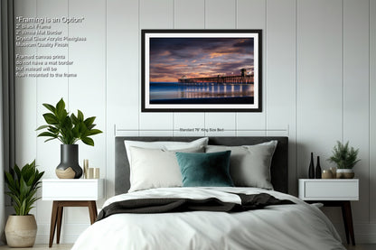 a bedroom with a bed and a picture hanging on the wall