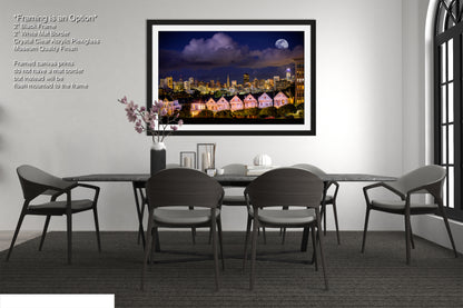 a dining room table with chairs and a picture hanging on the wall