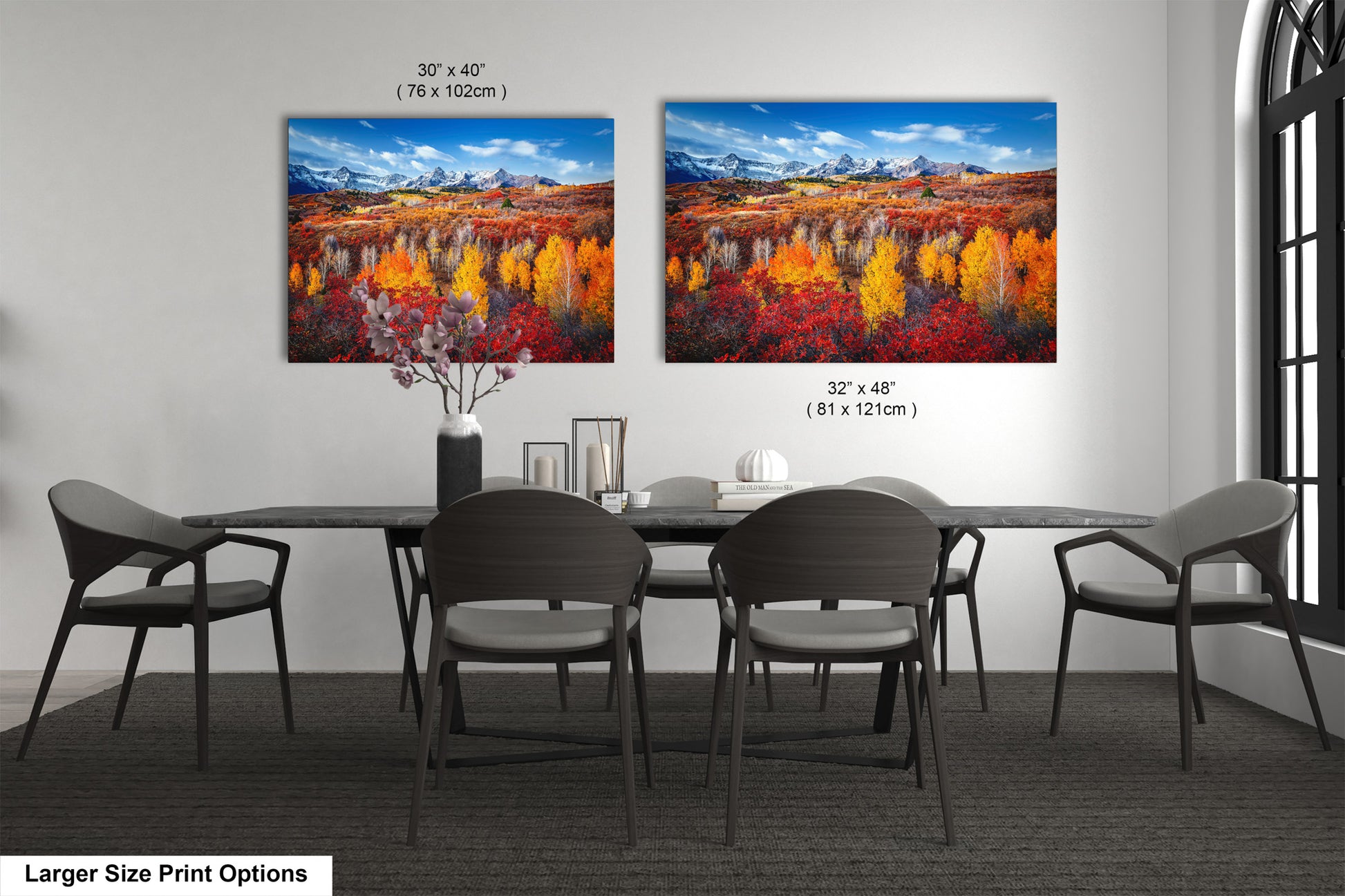 a dining room table with four chairs and a painting on the wall