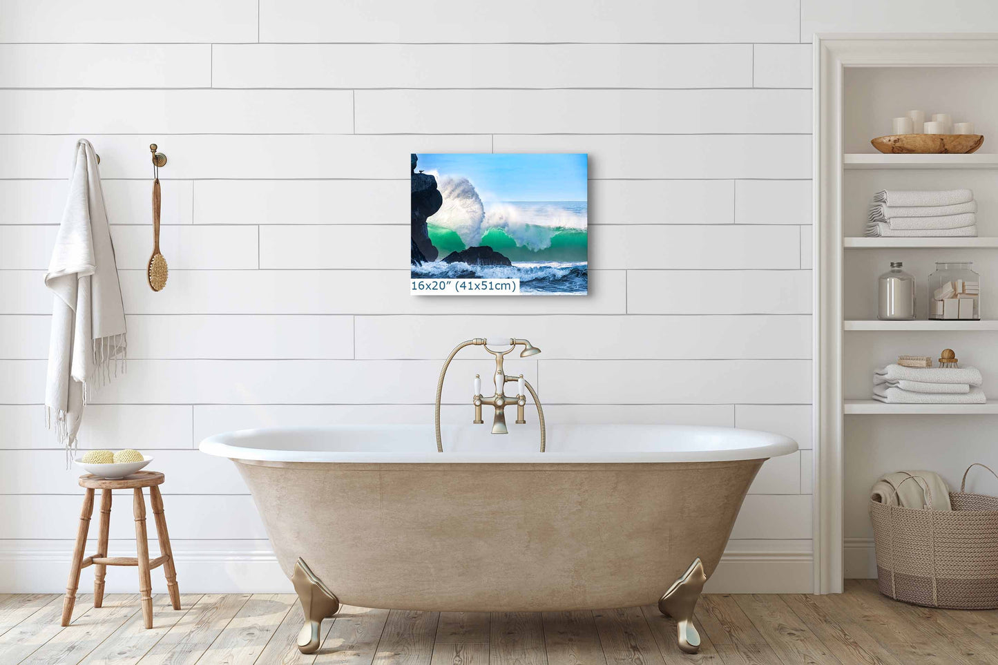 A 16x20 print of a cresting wave near Morro Rock, hanging above a vintage bathtub, complementing the bathroom&#39;s tranquility.