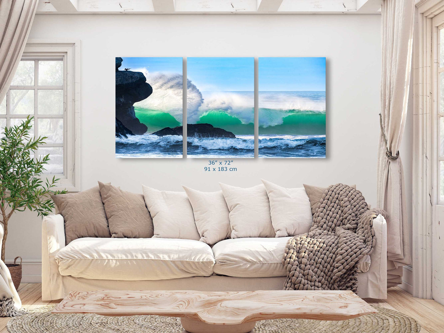 A 36x72 oversized canvas print of a dramatic ocean wave at Morro Rock, serving as an impressive centerpiece in a living room.